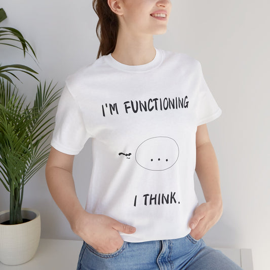 Funny anime t-shirt with the text “I’m Functioning… I Think” in a clean, minimalist font and a small anime face with dot-dot-dot expression. Worn by a smiling model in casual indoor light, the white tee captures subtle meme humor and relatable burnout energy. Perfect for fans of soft chaotic vibes, this shirt blends exhausted aesthetic with subtle otaku wit. Ideal for students, freelancers, or anyone whose brain is lagging but still trying its best.