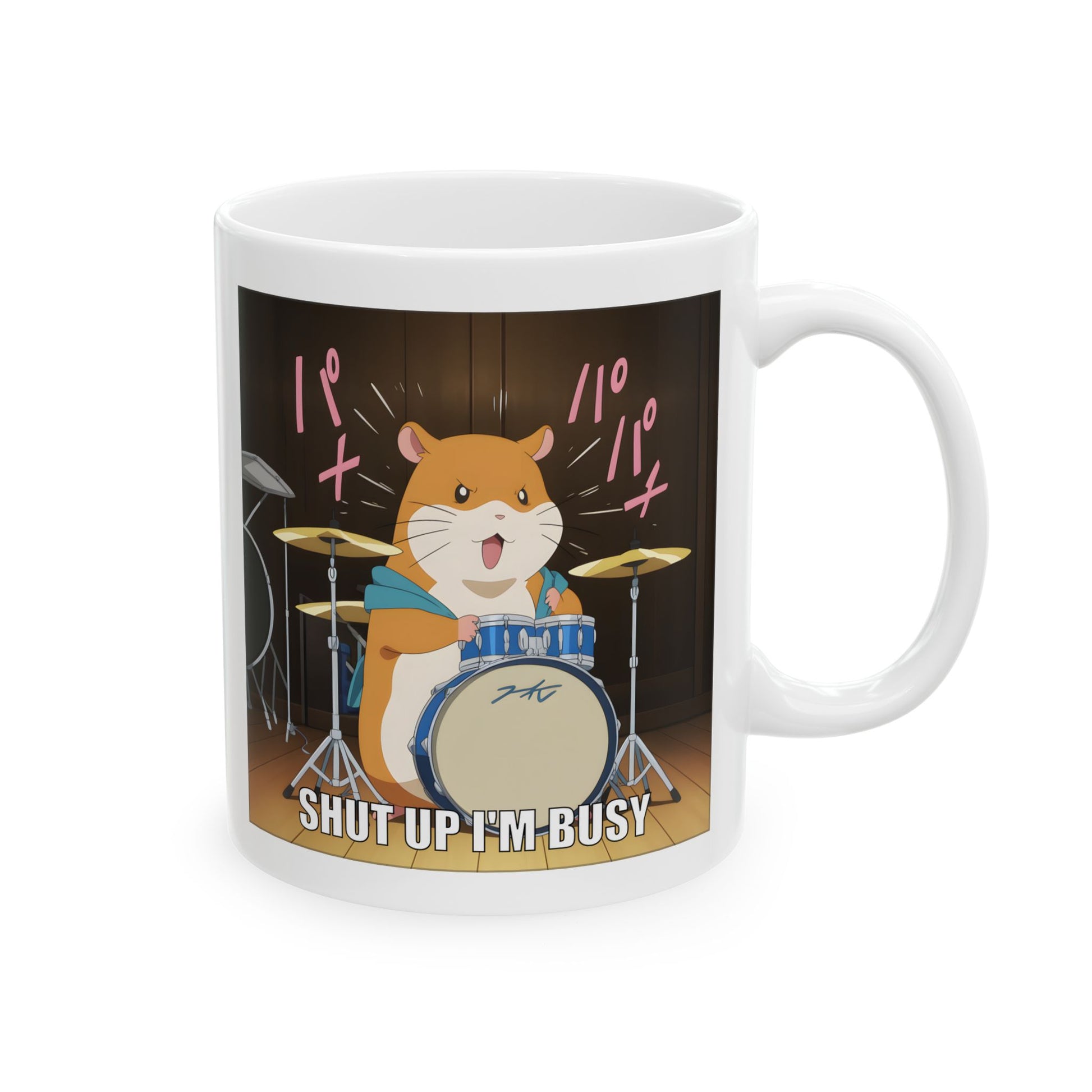 Hamster meme mug featuring a cartoon-style kawaii hamster playing drums with dramatic intensity. The hamster looks determined and angry, mid-solo, with motion lines and the caption “Shut up I’m busy” at the bottom. Printed clearly on a white ceramic mug, this design is loud, funny, and emotionally feral. Perfect for office workers, meme lovers, and anyone who expresses stress through noise and adorable rage.